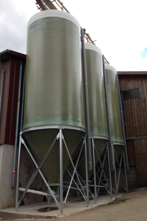 Three GRP silos for the storage of agricultural products.